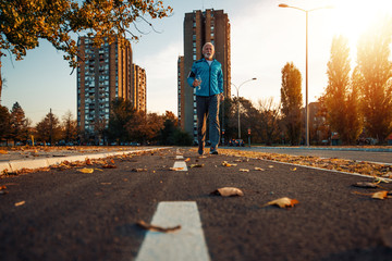 Active senior man practicing jogging in the city