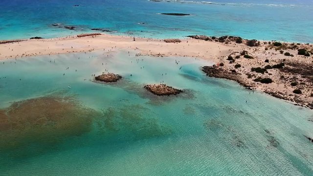 Stunning aerial of surfer paragliding at this island paradise of Elafonissi beach Crete, Greece