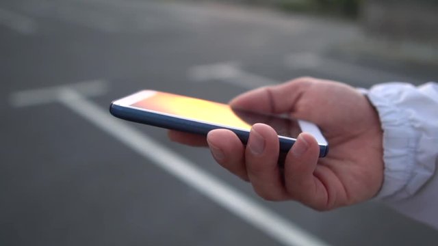 Phone in hand. Looking at phone, checking phone, call, parking, aplication