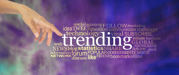 Let's take a look at what's trending concept word cloud - female hand point a finger at the word TRENDING surrounded by a word cloud against a modern purple abstract background