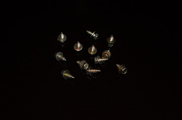screws and bolts on a dark background