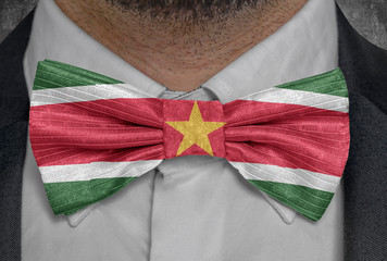 National flag of Suriname on bowtie business man suit