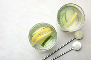 cup of  water with lemon and cucumber