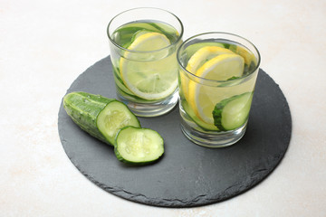 cup of  water with lemon and cucumber