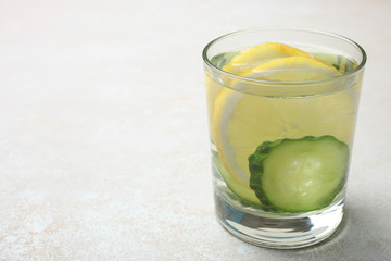 cup of  water with lemon and cucumber