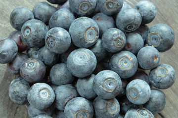 A handful of blueberries close up, natural forest garden blueberries without processing, close-up background