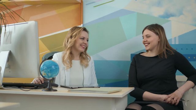 Travel agency. woman at office decide to travel choose country on globe with manager happy tourist