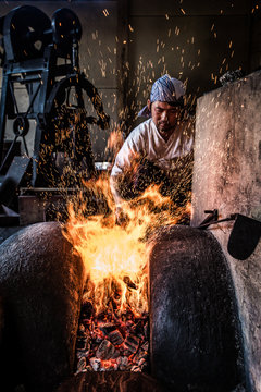 Japanese sword blacksmith who adjusts the fire