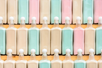 Beautifully placed on the rack original colored drinks in a row, fantastic texture.