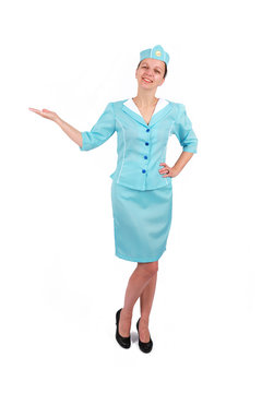 Stewardesse - Charming and smiling Stewardess Dressed In Blue Uniform Holding In Hand. Isolated on white background