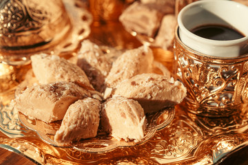 Turkish sweets with coffee on a wooden table