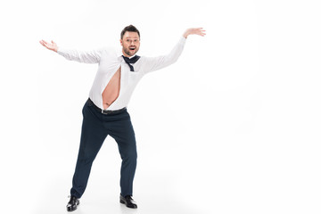 overweight man in tight formal wear gesturing and smiling isolated on white with copy space