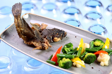 fried fish with vegetables. Roast goby