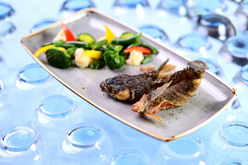fried fish with vegetables. Roast goby