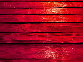 Bright red fence. Orange color fence boards.