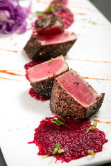 gourmet seared tuna in black pepper crust with beetroot coulis