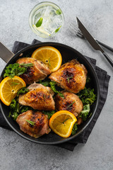 Chicken thighs with orange is a pan.