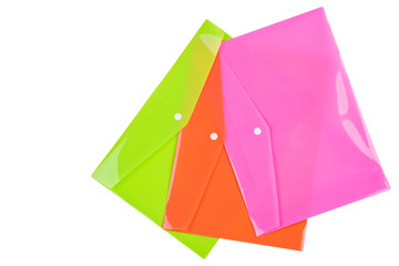 three multicolored plastic folders for documents, laid out on a white background, office concept, isolate