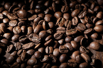 Coffee beans background. Close up. Dark photo.