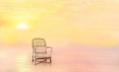 Fantastic resting place. An old chair in the middle of the water in the fog and the golden light of sunset.  Long exposure, minimal landscape.