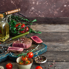 cut meat with blood vegetables oil bread around wooden table