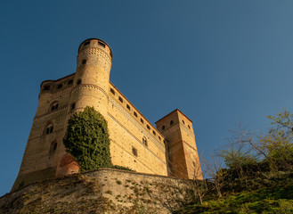 Low angle view of the medieval Castle of Serralunga d'Alba (1340-1357), considered to be one of the best-conserved examples of 14th century noble castles in Piedmont, Langhe region, Italy