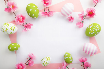 Holidays background with Easter eggs on pink table