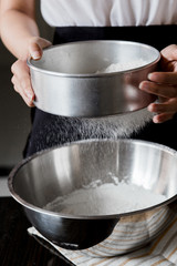 Sifting flour through a sieve