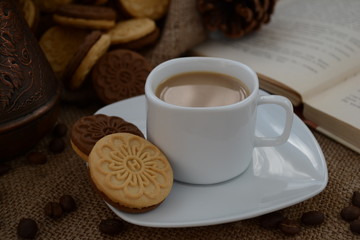 A cup of coffee. While reading a book, have a cup of coffee with cookies. Stop for a minute, coffee is a pleasure.