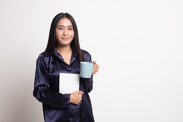 Fototapeta premium Young Asian woman with a book and cup of coffee.