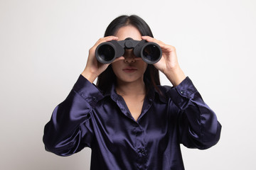 Young Asian woman with binoculars.