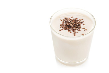Oat milk in a glass dusted with flax grains