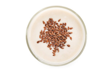 Oat milk in a glass dusted with flax grains