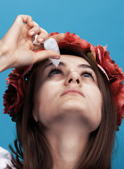 Woman burying her eyes with drops