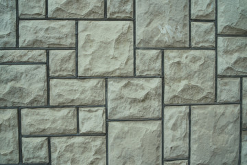 Simple rock blocks background Backdrop of textured uneven gray stone blocks in wall design