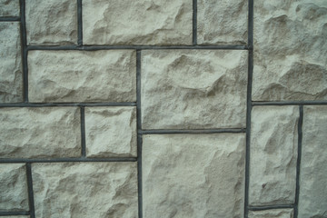 Simple rock blocks background Backdrop of textured uneven gray stone blocks in wall design