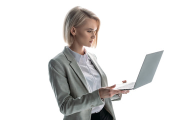 pretty, blond, attentive businesswoman holding laptop isolated on white