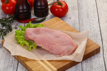 Raw Turkey steak served rosemary