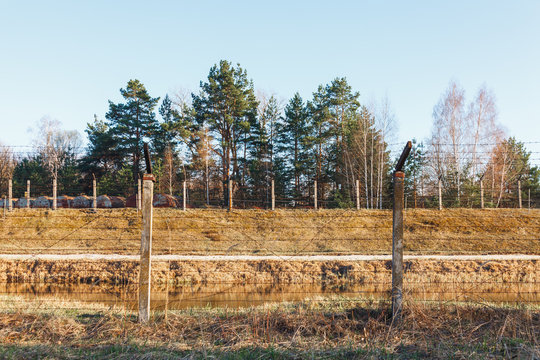 Dangerous area fenced with barbed wire fence