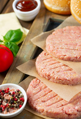 Burger patties on wooden surface