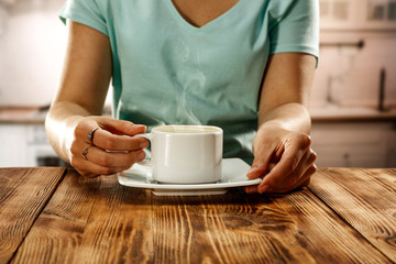 Hot coffee and woman hands 