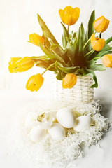 Fototapeta na wymiar Easter still life. Gentle bright photo of egg and and bright tulips.