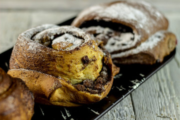 sweet buns on a rough wooden background