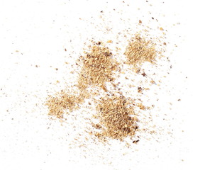 Ground, milled nutmeg powder isolated on white background, top view