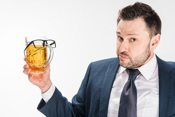 chubby man in formal wear looking at camera while holding glass of beer with glasses on isolated on white