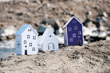 Miniature white houses as a model house. Three souvenir houses. The house is made of plastic on the...