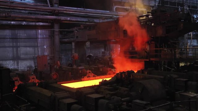 Steel plant, production of steel sheets, transportation of hot sheets on the production line, heavy industry, metal rolling plant. Conveyor line metal rolling mill.