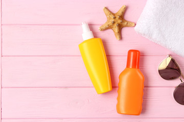  seashells and sunscreen on a colored background top view. Sunscreen
