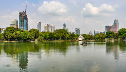 Reflection of skyscrapers in Lumpini Park, Bangkok, Thailand
