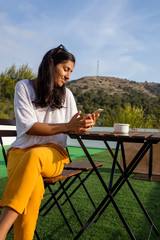 Young indian woman typing a massage